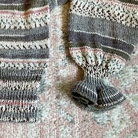 cropped image of a knit cardigan with puffy sleeves